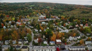 AX150_375 - 5.5K aerial stock footage flying by neighborhood, Vermont College of Fine Arts, autumn, Montpelier, Vermont