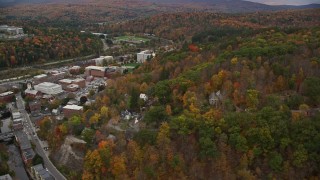 AX150_380 - 5.5K aerial stock footage flying by downtown buildings, panning right to colorful trees, Montpelier, Vermont
