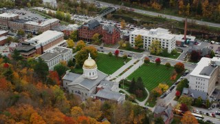 AX150_381 - 5.5K aerial stock footage flying by Vermont State House, green lawns, colorful foliage, autumn, Montpelier, Vermont