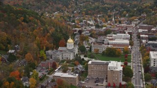 AX150_381E - 5.5K aerial stock footage flying by Vermont State House, green lawns, colorful foliage, autumn, Montpelier, Vermont