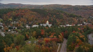 AX150_384E - 5.5K aerial stock footage flying by Vermont State House, revealing office buildings, autumn, Montpelier, Vermont