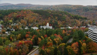 AX150_385 - 5.5K aerial stock footage flying by Vermont State House, revealing office buildings, autumn, Montpelier, Vermont