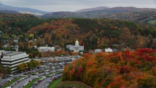 AX150_386 - 5.5K aerial stock footage flying by office building, Vermont State House, autumn, Vermont State House