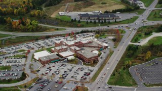 AX150_396 - 5.5K aerial stock footage flying by Central Vermont Medical Center, tilt down, autumn, Barre, Vermont