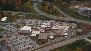 AX150_396E - 5.5K aerial stock footage flying by Central Vermont Medical Center in autumn, Barre, Vermont