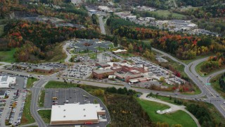 AX150_398 - 5.5K aerial stock footage flying away from Central Vermont Medical Center, autumn, Barre, Vermont