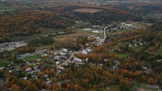 AX150_400E - 5.5K aerial stock footage flying over the small town of Williamstown, Vermont, and tilting to a church on Main Street