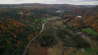 AX150_402E - 5.5K aerial stock footage following Main Street through the small town of Williamstown, Vermont in autumn