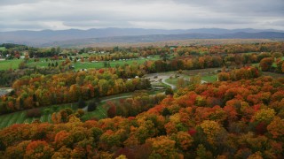AX150_407 - 5.5K aerial stock footage flying by a cemetery, brightly colored trees, autumn, Randolph Center, Vermont