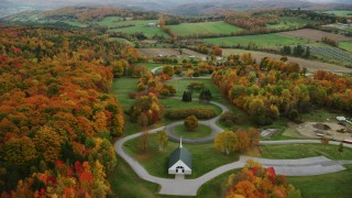 AX150_408 - 5.5K aerial stock footage orbiting cemetery, colorful trees in autumn, Randolph Center, Vermont