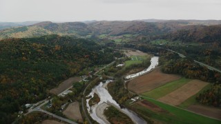 AX150_424 - 5.5K stock footage aerial video flying over small farms, White River, Route 14 in autumn, South Royalton, Vermont