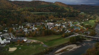 AX150_430 - 5.5K aerial stock footage orbiting small rural town, White River, small bridge, autumn, South Royalton, Vermont