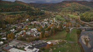 AX150_430E - 5.5K aerial stock footage orbiting small rural town, White River, small bridge, autumn, South Royalton, Vermont