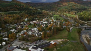 AX150_431 - 5.5K aerial stock footage orbiting small rural town along the White River, autumn, South Royalton, Vermont