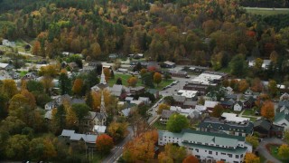 AX150_435 - 5.5K aerial stock footage orbiting small rural town, colorful foliage in autumn, South Royalton, Vermont