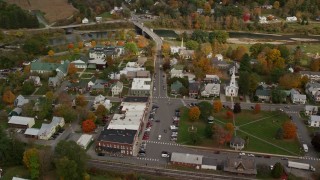 AX150_438E - 5.5K aerial stock footage orbiting small rural town, town square, churches, shops, autumn, South Royalton, Vermont