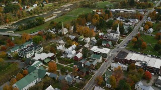 AX150_439 - 5.5K aerial stock footage orbiting town square, churches, small rural town in autumn, South Royalton, Vermont