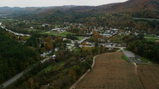AX150_440 - 5.5K stock footage aerial video approaching White River, small bridge, small rural town in autumn, South Royalton, Vermont