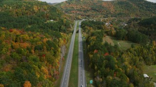 AX150_453 - 5.5K stock footage aerial video flying over interstate 89 through colorful trees in autumn, Sharon, Vermont