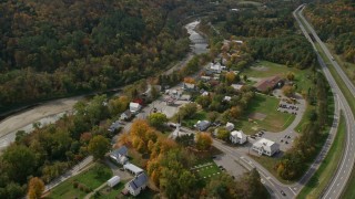 AX150_455E - 5.5K aerial stock footage orbiting a small rural town, colorful foliage in autumn, Sharon, Vermont