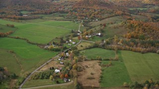 AX150_459 - 5.5K stock footage aerial video flying by farms, grassy clearings, Stage Road, autumn, North Pomfret, Vermont