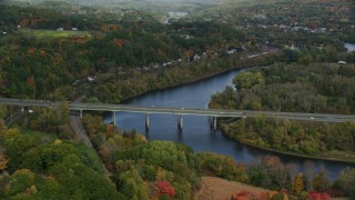 AX150_474 - 5.5K aerial stock footage flying by Interstate 89, small bridge, Connecticut River, autumn, Lebanon, New Hampshire