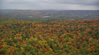 AX151_002E - 5.5K aerial stock footage flying over densely forested hills, autumn, White River Junction, Vermont