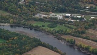 AX151_048E - 5.5K aerial stock footage flying by hedge maze, park along Connecticut River, autumn, Hartland, Vermont