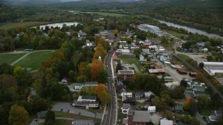 AX151_061 - 5.5K stock footage aerial video flying over Main Street through small rural town, autumn, Windsor, Vermont