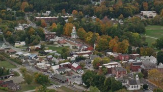 AX151_063E - 5.5K aerial stock footage flying by a small rural town, brightly colored foliage, autumn, Windsor, Vermont