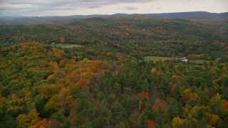 AX151_065E - 5.5K aerial stock footage flying over colorful forest, hills, revealing farms, autumn, Cornish, New Hampshire
