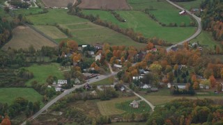 AX151_069E - 5.5K aerial stock footage flying by small rural town, grassy clearings, foliage, autumn, Cornish, New Hampshire