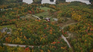 AX151_081 - 5.5K aerial stock footage flying over mansion, approach small islands, Lake Sunapee, autumn, Sunapee, New Hampshire