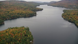 AX151_084 - 5.5K aerial stock footage flying over waterfront homes, colorful forest, Lake Sunapee, autumn, Newbury, New Hampshire