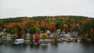 AX151_090 - 5.5K aerial stock footage flying over Lake Sunapee and by waterfront homes, autumn, Newbury, New Hampshire