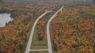 AX151_096 - 5.5K aerial stock footage flying by Interstate 89 though forest, autumn, overcast, New London, New Hampshire