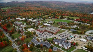 AX151_099 - 5.5K aerial stock footage orbiting Colby Sawyer College, colorful foliage, autumn, New London, New Hampshire