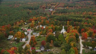 AX151_130E - 5.5K aerial stock footage orbiting a small rural town, colorful trees, autumn, Webster, New Hampshire