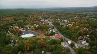 AX151_144 - 5.5K stock footage aerial video flying by Main Street, small town neighborhood, autumn, Penacook, New Hampshire