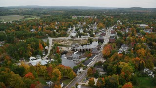 AX151_148 - 5.5K stock footage aerial video orbiting Main Street, small town, Contoocook River, autumn, Penacook, New Hampshire