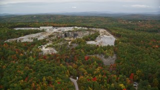 AX151_161 - 5.5K aerial stock footage orbiting a quarry, colorful foliage, autumn, overcast, Concord, New Hampshire