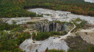 AX151_163 - 5.5K aerial stock footage orbiting a quarry with colorful foliage in autumn, Concord, New Hampshire