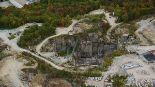 AX151_165 - 5.5K aerial stock footage orbiting cranes, quarry, colorful foliage in autumn, Concord, New Hampshire