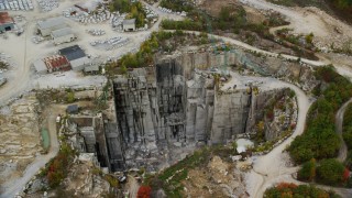 AX151_167 - 5.5K aerial stock footage orbiting equipment in and around a quarry, autumn, Concord, New Hampshire