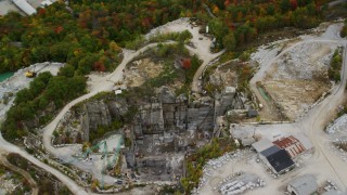 AX151_169 - 5.5K aerial stock footage orbiting a quarry, cranes, foliage in autumn, Concord, New Hampshire