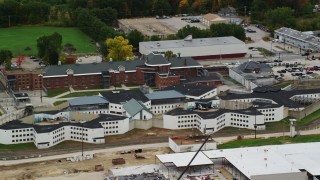 AX151_172 - 5.5K stock footage aerial video flying by the New Hampshire State Prison in autumn, Concord, New Hampshire