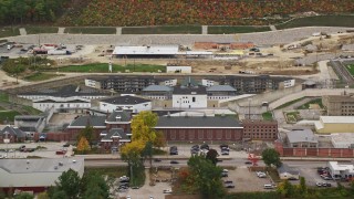 AX151_176 - 5.5K aerial stock footage orbiting New Hampshire State Prison, baseball diamond, light traffic passing by, autumn, Concord, New Hampshire