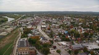 AX151_178E - 5.5K aerial stock footage flying over homes and downtown, by St Paul's Church, New Hampshire State House, autumn, Concord, New Hampshire