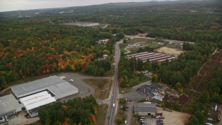 AX152_001 - 5.5K aerial stock footage flying over warehouse buildings, Sheep Davis Road, autumn, Pembroke, New Hampshire