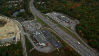 AX152_008 - 5.5K aerial stock footage approaching strip malls, Interstate 93, tilt down, autumn, Bow, New Hampshire